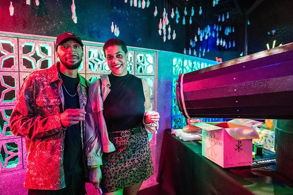 Trendy couple enjoying cocktails during a colorful evening inside FloridaRAMA — a vibrant and unique date spot in Tampa Bay.