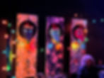 Festively decorated bar with colorful lights and art at a corporate holiday party.