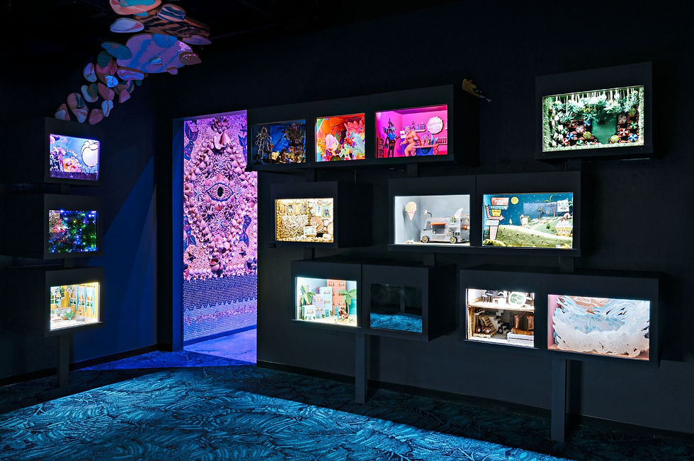A wall of glowing dioramas at FloridaRAMA, each depicting whimsical scenes inspired by Florida myths and legends.