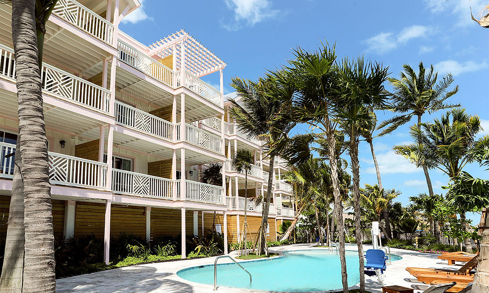 Florida Keys fishing hotel with pool, palm trees, and guest rooms at Grassy Flats Resort in Marathon