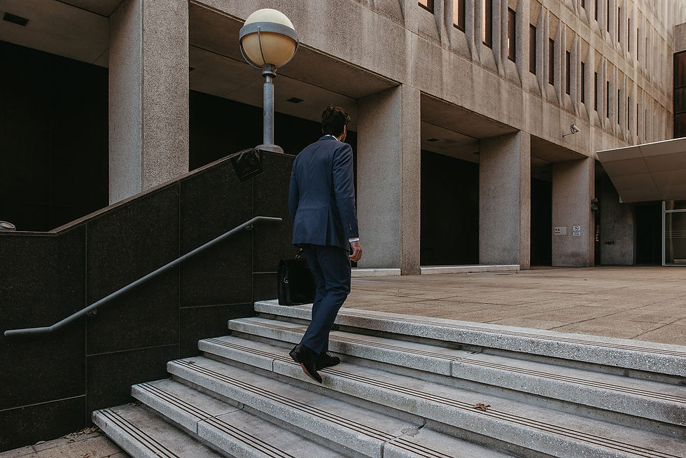 Personal Injury Lawyer Taylor Burnham climbing the stairs going to the court