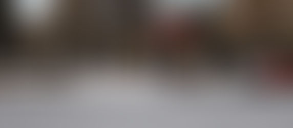 People and a cyclist cross a street near a red truck. Trees with autumn leaves in the background. Street sign reads Sherbrooke.