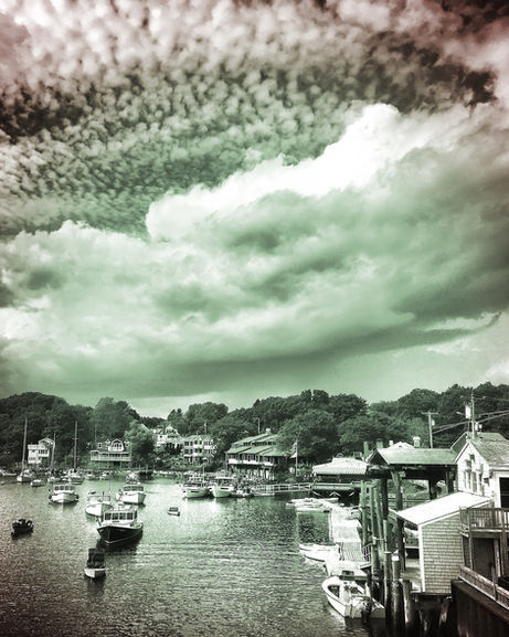 Boats in the basin with a dramatic cloudy sky in Perkins Cove, Maine