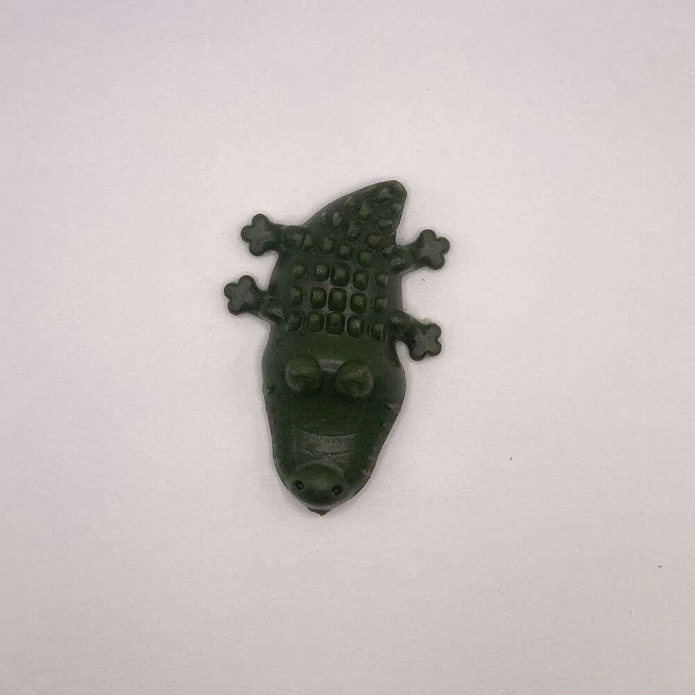 Thumbnail: Single green crocodile-shaped dental chew bite photographed against a white background.
