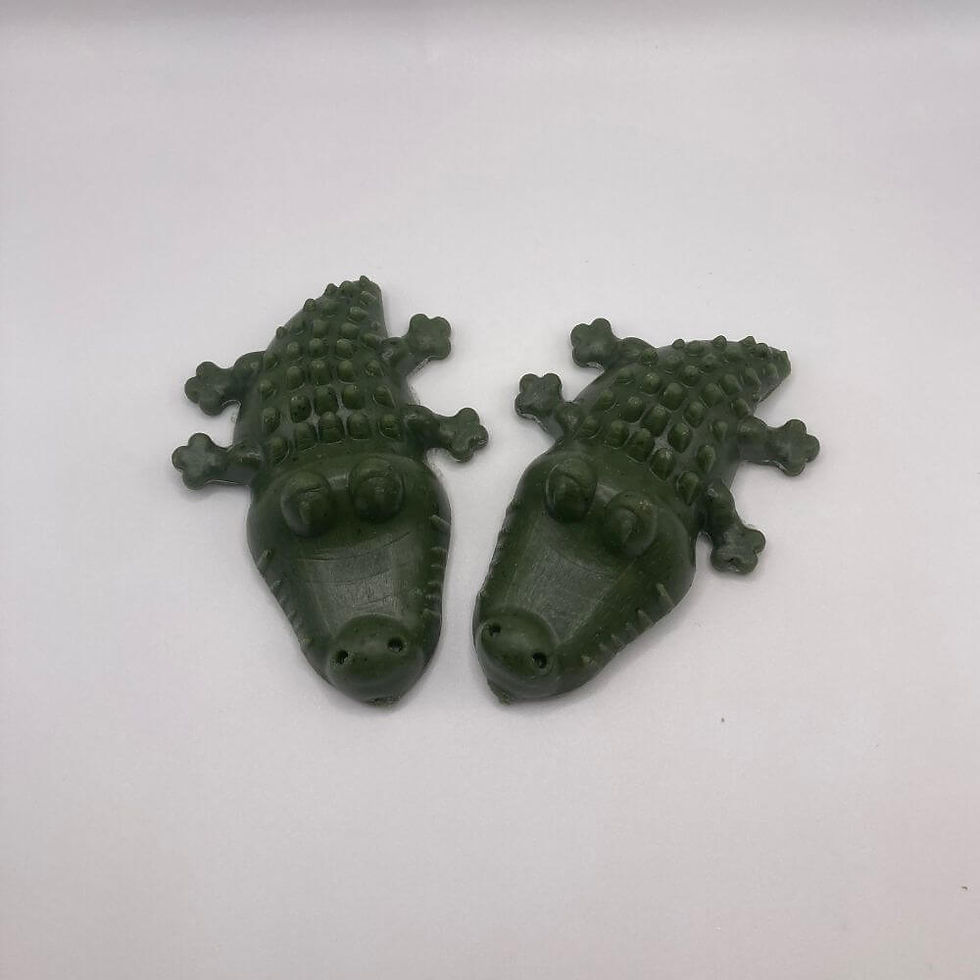 Thumbnail: Two green crocodile dental chew bites on a white surface with soft shadow.