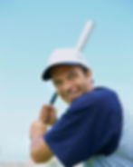 A baseball player gets ready to take a swing and hit the ball.