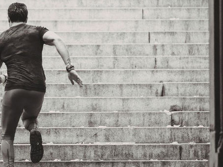 A man runs up the stairs to show his determination.