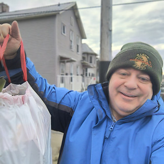 Randy McNeely - Captain Kindman - with full garbage bag.