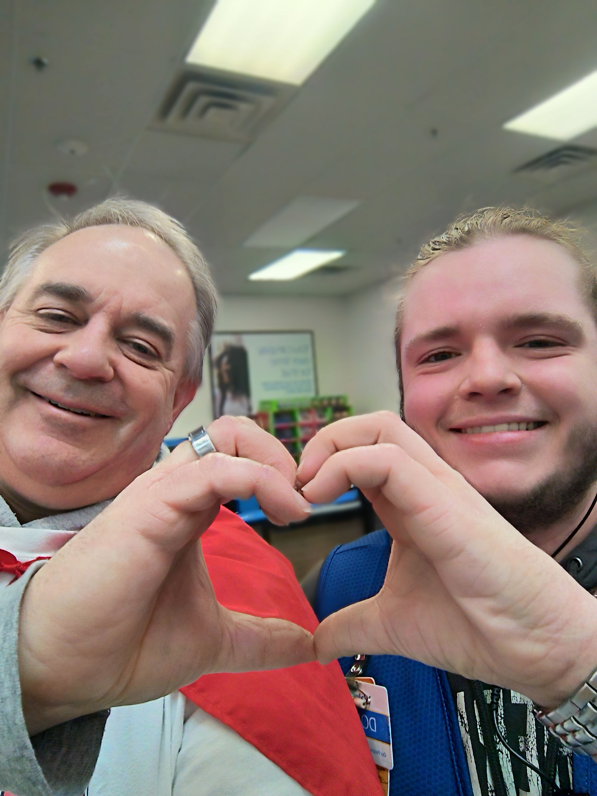 Captain Kindman makes a heart with Devan