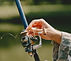 man-fishing-holds-angling-rod.jpg