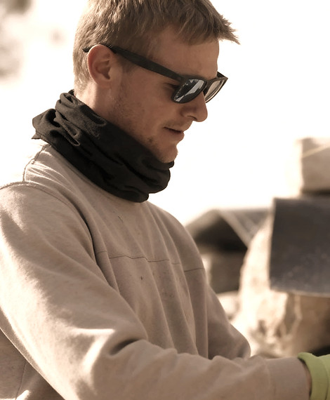 a stone mason building a wall