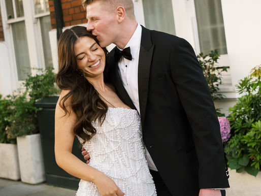 Groom kissing the top of his wife’s head during an intimate, mindful wedding moment