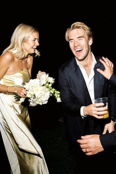 Guests laughing and celebrating during an evening wedding in Italy, captured by London wedding photographer Keidi Vaikma.