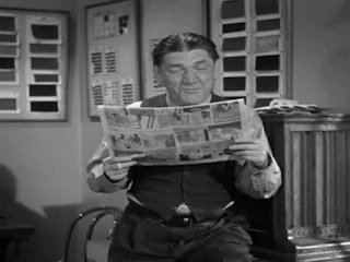 Shemp reads a newspaper