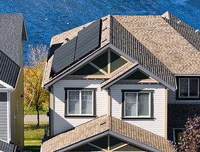 Home exterior with rooftop solar panels visible along the roofline