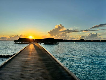 A pier leading into a beautiful ocean in the Maldives