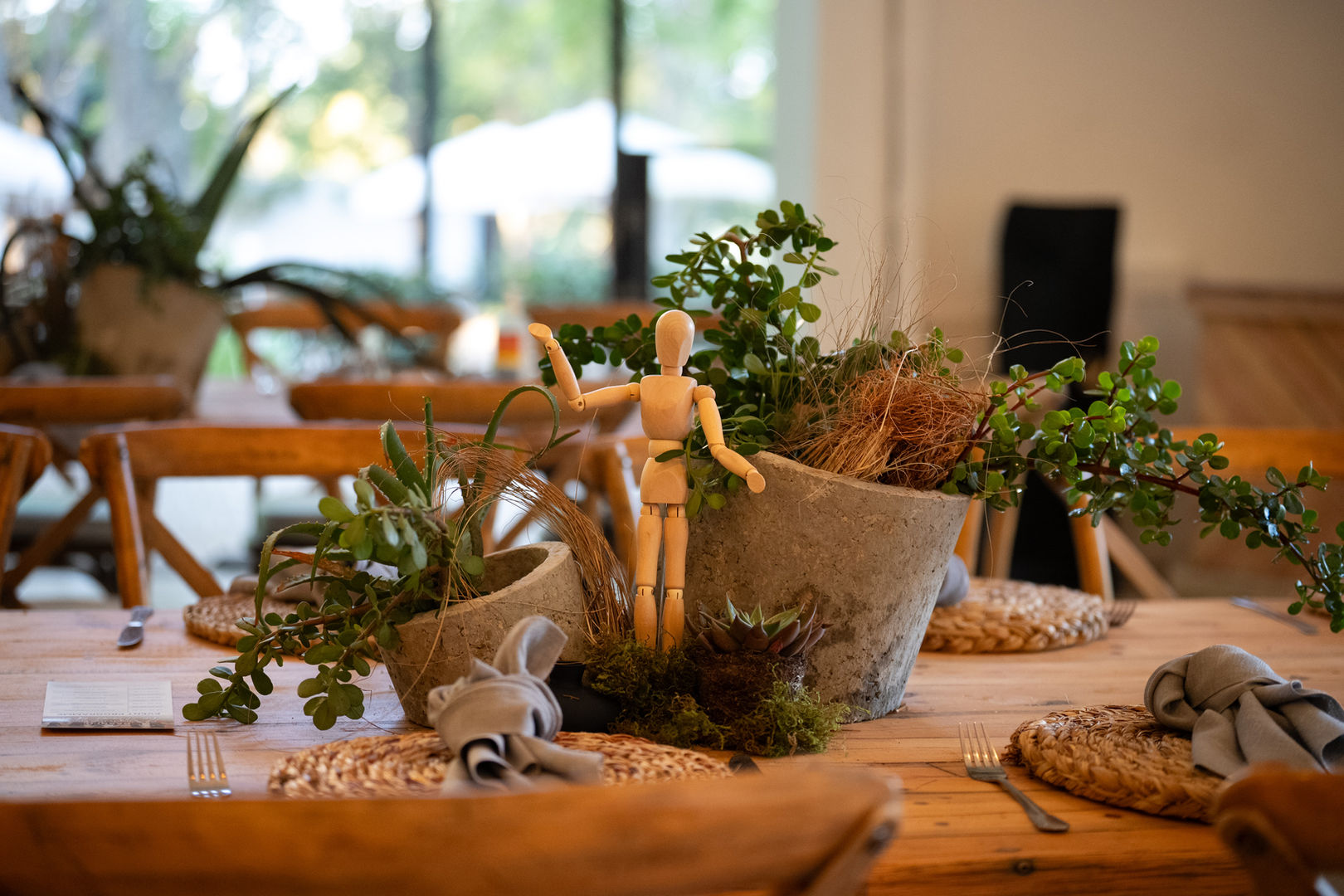 Organic palette of lush greens, cement vases, wooden figurines, and sculptural elements allows for this beautiful morning awards.