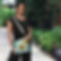 a woman carrying Gilded Breeze aqua tropical print vegan crossbody