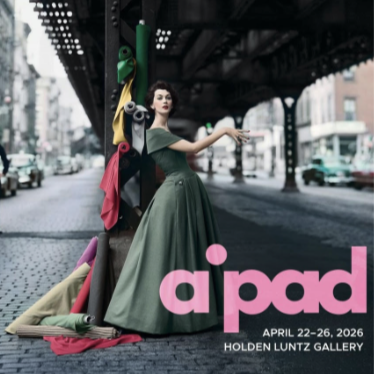 Woman in a green dress poses with colorful fabrics on a city street. Text: "aipad April 22-26, 2026, Holden Luntz Gallery."