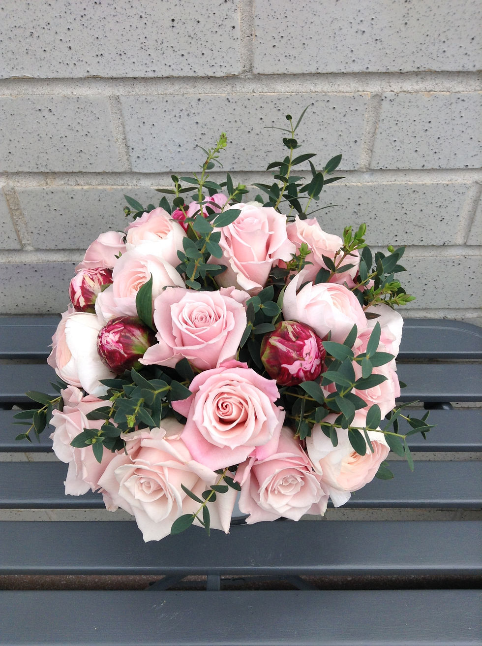 A hint of peonies in a rose arrangement