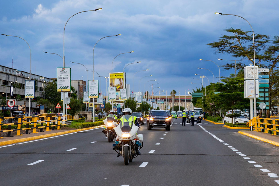 A convoy of police escorts and premium cars driving out of JKIA