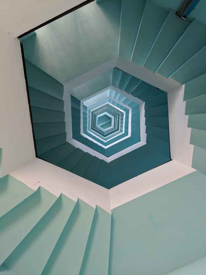 empty gray and white concrete spiral stairs