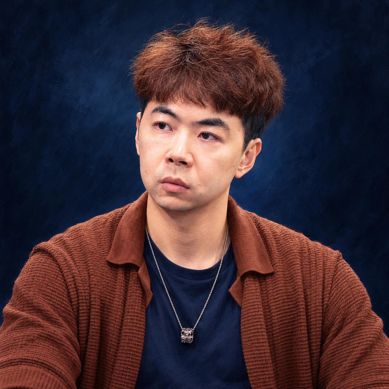 Editorial illustrated portrait of Pete Chen with tousled brown hair, a rust knitted shirt and silver necklace against a dark indigo background.