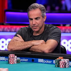 Cliff Josephy seated at a poker table during a televised tournament with stacks of poker chips in front of him.