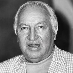 Black-and-white portrait of poker player Joe Bernstein wearing a checkered jacket and light-colored shirt.