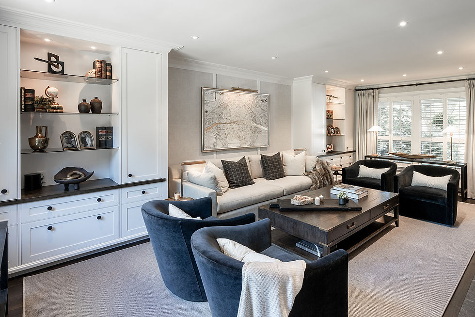 living room renovation with custom white built in custom book shelves and panelled accent wall