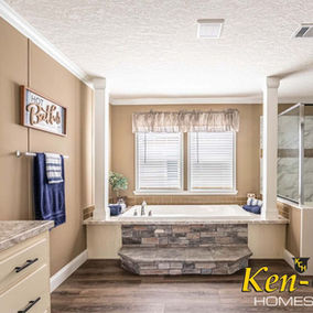 Bathroom interior with tub and shower, Ken-Co Homes, beige wall with window.