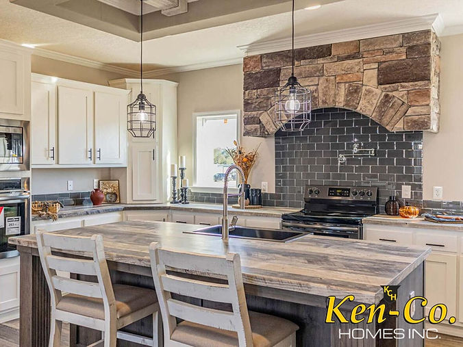 Modern kitchen with Ken-Co. Homes logo, countertops, and appliances in the background.