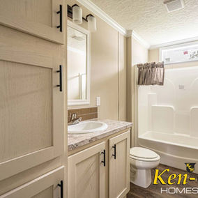 Bathroom with cabinets, sink, toilet, and shower; Ken-Co Homes Inc.
