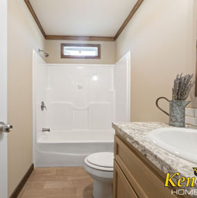 Bathroom interior with shower, sink, and toilet; Ken-Co Homes visible in image.