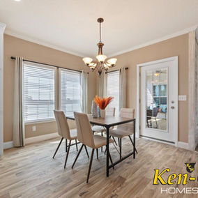 Dining room with table and chairs. Ken-Co Homes Inc. Timberview 32663E. Interior view.