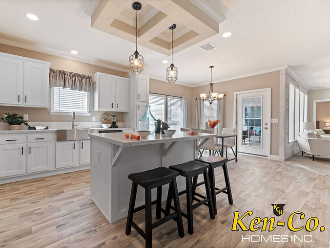 Modern kitchen with white cabinets and Ken-Co Homes branding visible.