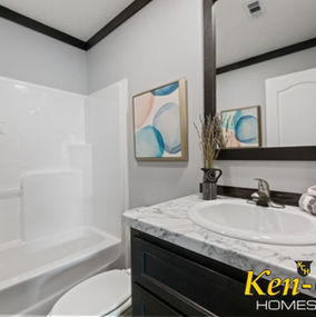 Bathroom with sink, mirror, and Ken-Co Homes branding in a modern style.