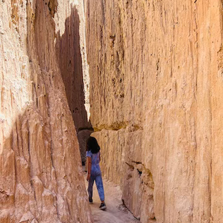 Enjoying the cool air in a slot canyon at Cathedral Gorge