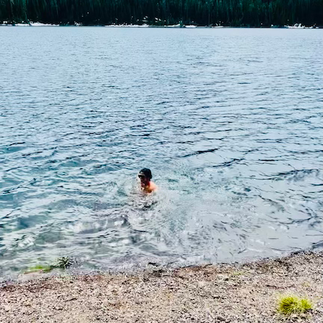 Woman cold plunging at Hyalite Canyon