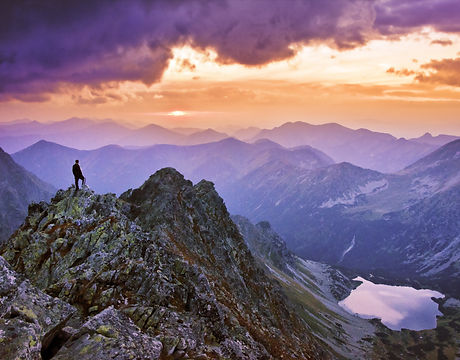 Tourist stand on the top of big mountain