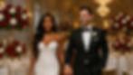 Bride and groom standing inside their white wedding reception, holding hands with soft focus in the background.