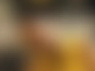 Luisa in a yellow dress with a mango juice on the table