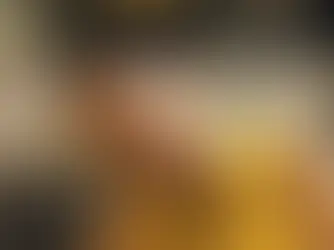 Luisa in a yellow dress with a mango juice on the table