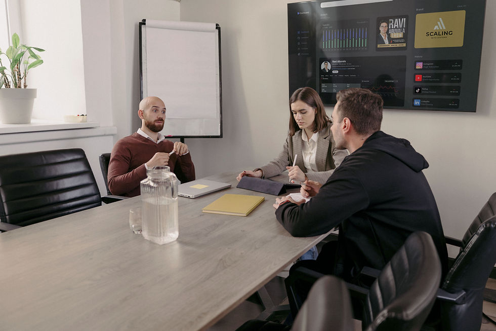 Team strategizing content for Ravi Abuvala of Scaling With Systems, with his media dashboard displayed on the screen in the background.