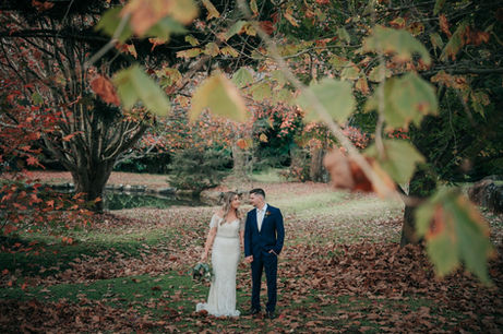 Bride and groom autumn leaves