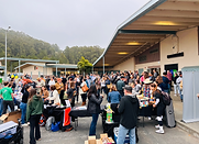A large gathering of people, mostly adults, at Half Moon Bay High School