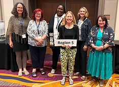 Sophia standing with five colleagues, one holding a 'Region 5' sign
