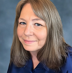 Headshot of a women with light brown-grey hair and side swept bangs
