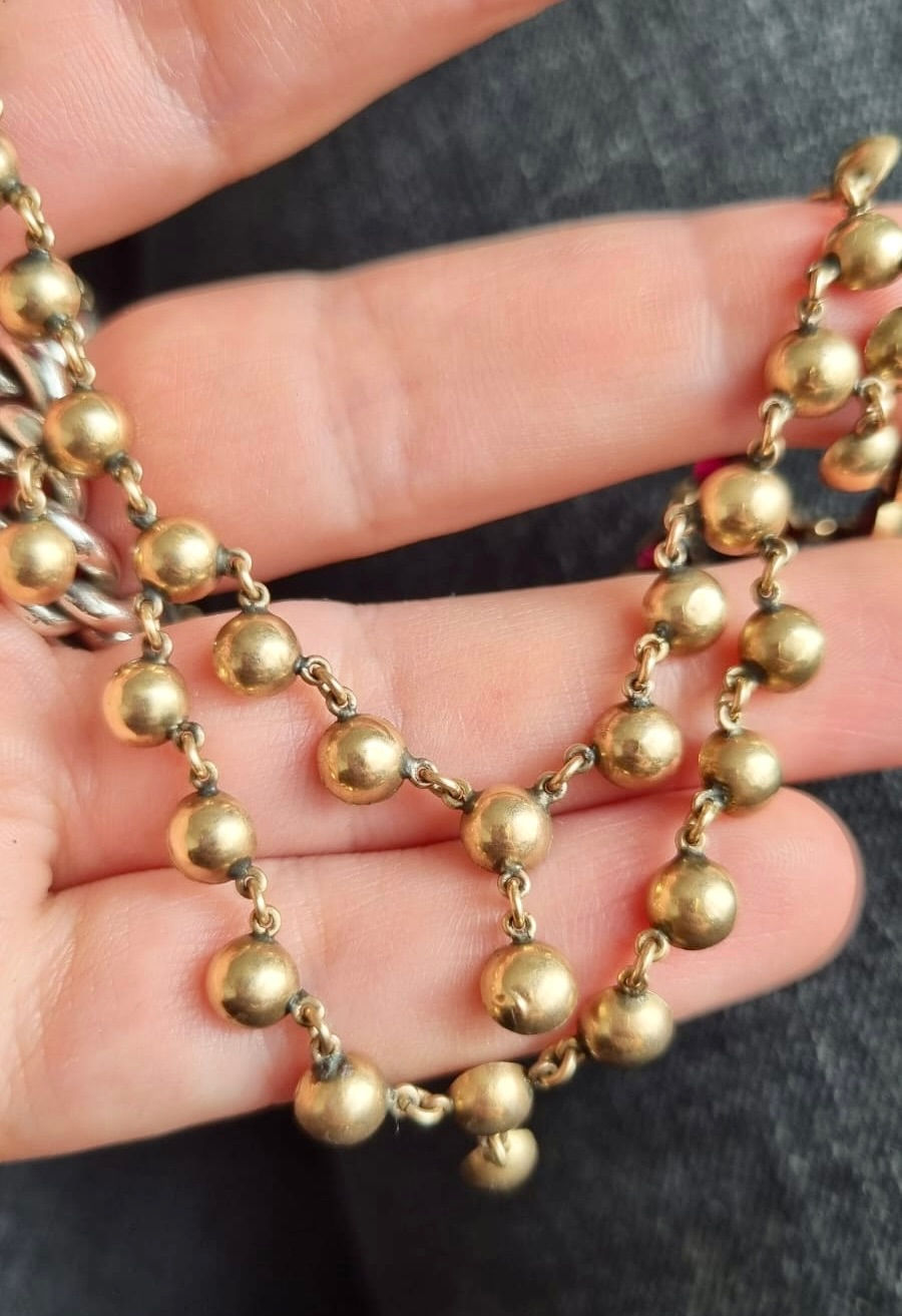 Thumbnail: Stunning Antique Georgian 9K Gold Reversible Garnet Fringe Swag Necklace