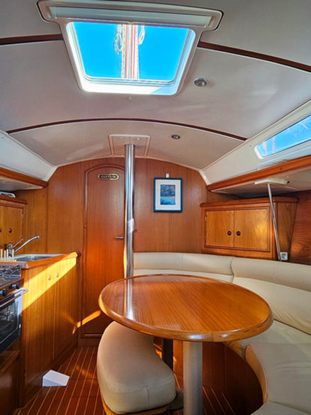 Wooden interior of a sailing boat, a cozy dinette, a yacht charter